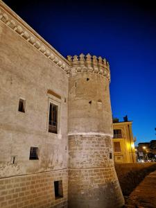 Um edifício de tijolos com um céu nocturno por trás. em B&B L'ABBAZIA em Torre Maggiore