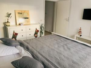 a bedroom with a large bed and a dresser at Condmari Residential Apartament in Braşov