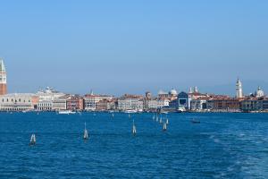a group of sailboats in the water with a city in the background at A Tribute To Music Residenza in Venice