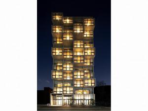 a tall building with illuminated windows at night at 9 HOTEL Hakata in Fukuoka