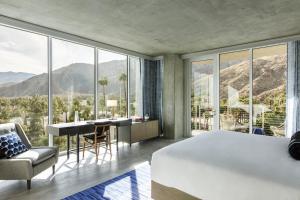 a living room with a large window overlooking a lake at Kimpton Rowan Palm Springs Hotel, an IHG Hotel in Palm Springs