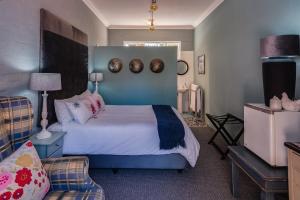 a bedroom with a bed with a blue head board at Latest Unit with en suite, wi-fi and DSTV in Port Elizabeth