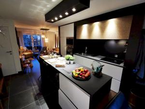 a kitchen with a bowl of fruit on a counter at L'Atelier in Houyet