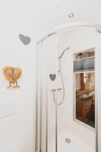 a shower with a glass door in a bathroom at Gasthof Berghof in Semmering