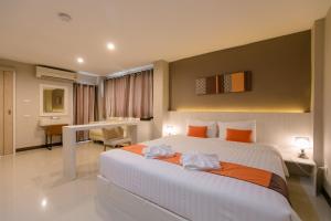 Ένα ή περισσότερα κρεβάτια σε δωμάτιο στο De Hug Hotel & Residence