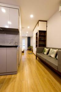 a living room with a couch and a kitchen at Nexy Living in Hanoi