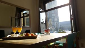 a table with a tray of food and two glasses at Holiday Home Alice House in Ieper