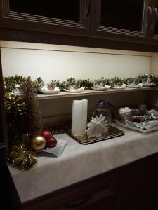 a counter with christmas decorations on a shelf at Guest House Geralda on Nevskiy in Saint Petersburg