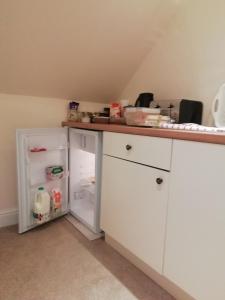 a kitchen with a white counter and an open refrigerator at The Oaklodge in Newark-on-Trent