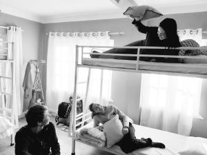 a group of people sitting on a bunk bed at KAJI HOME in Pātan