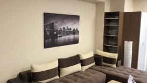a living room with a couch and a painting on the wall at При Павката (Pri Pavkata) in Samokov