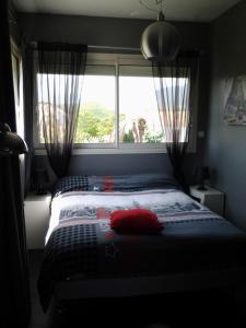 a bedroom with a bed with a large window at Villa de charme avec piscine in Ghisonaccia +46 photos