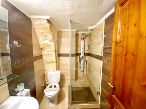 a bathroom with a toilet and a glass shower at Boutique Hotel Del Doge in Chania