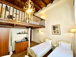 a bedroom with two beds and a staircase at Boutique Hotel Del Doge in Chania