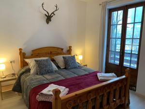 a bedroom with a large wooden bed with pillows at White Rock in Ponte di Legno