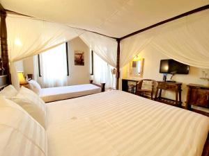 Postel nebo postele na pokoji v ubytování Boutique Hotel Del Doge