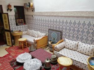 a living room with two couches and a table at Dar Margot Marrakech in Marrakesh