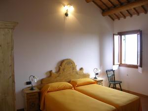 a bedroom with a bed with yellow sheets and a window at Agriturismo Zennare in Chioggia