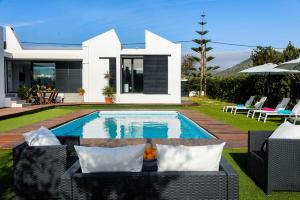 a villa with a swimming pool in front of a house at Villa Anur in Sant Josep de Sa Talaia
