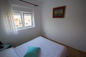 niewielka sypialnia z łóżkiem i oknem w obiekcie Villa Maria w mieście Novigrad