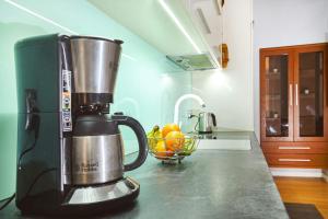 a kitchen with a blender on a counter with a bowl of fruit at BlueApart in Krakow