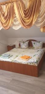 een bed met een houten frame en een baldakijn bij Mlynski in Mykulychyn