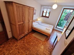 a small bedroom with a bed and a wooden cabinet at Authentico Deluxe Stari Grad in Stari Grad