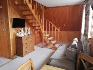 a living room with a staircase in a house at Apartament u Tomka in Zakopane