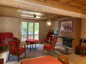 a living room with a table and chairs and a fireplace at Chalet Minga Mal in Saas-Fee