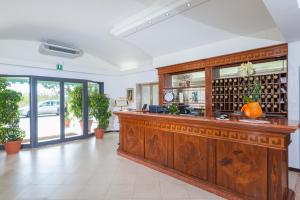 a lobby with a large wooden bar in a building at Hotel Suisse in Marina di Pietrasanta