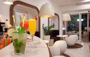 two drinks on a table in a restaurant at Hotel Plaza in Sorrento