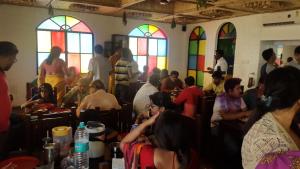 a group of people sitting in a room with stained glass windows at Panthashala Santiniketan in Srī Niketan +99 photos