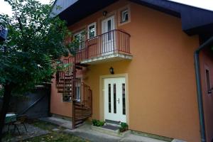 a house with a balcony and a staircase at Apartman Carpe Diem 2 in Zaječar