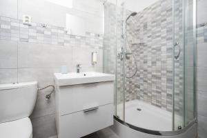 a bathroom with a toilet and a sink and a shower at Jizerské hory, apartmány, zahrada, Penzion Pod Sudem in Lázně Libverda +102 photos