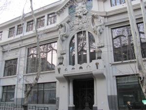 a large white building with a large window at Lucky Travelers Room in Tbilisi City