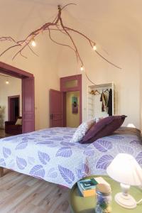 a bedroom with a bed with a blue comforter at Politeama apartment in Palermo