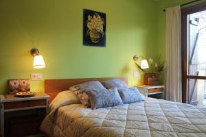 a bedroom with a large bed with green walls at Apartamentos Ball Benas Edificio Mirador in Cerler