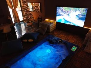 a living room with a tub in front of a tv at Dimora nel Benessere in Monopoli