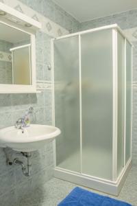 a bathroom with a shower and a sink at Apartments Pri Marjetki in Cerkno