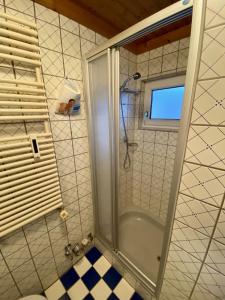 a shower with a glass door in a bathroom at Posthof 37 in Kitzbühel