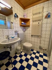 a bathroom with a toilet and a sink at Posthof 37 in Kitzbühel