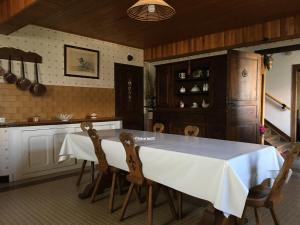 a kitchen with a white table and chairs at Maison bigourdane in Ayzac-Ost