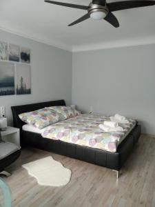 a bedroom with a bed and a ceiling fan at Our Haven in 1220 in Vienna