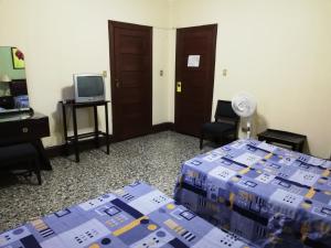a room with boxes on a bed and a television at Hotel De Gante in San Luis Potosí
