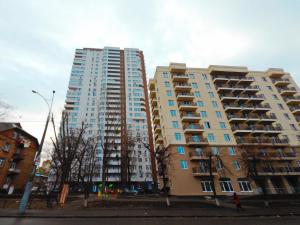 two tall apartment buildings next to each other at Сказочно волшебная квартира Соломенском районе Добробут in Kyiv
