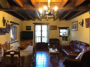 un soggiorno con divano e TV di Casa Rural La Xana a Piloña