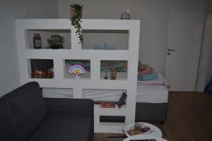 a living room with a couch and a bed at Apartman Dejna in Sarajevo