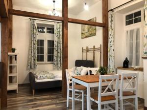 a dining room with a table and chairs and a couch at Dunakavics Boutique Apartman Szentendre in Szentendre