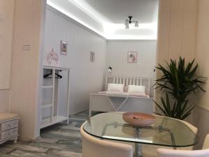 a living room with a glass table and chairs at Dunakavics Boutique Apartman Szentendre in Szentendre +51 photos