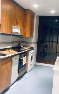 una cocina con lavadora y lavadora en Luxurious duplex penthouse with golf and sea views, en Benalmádena